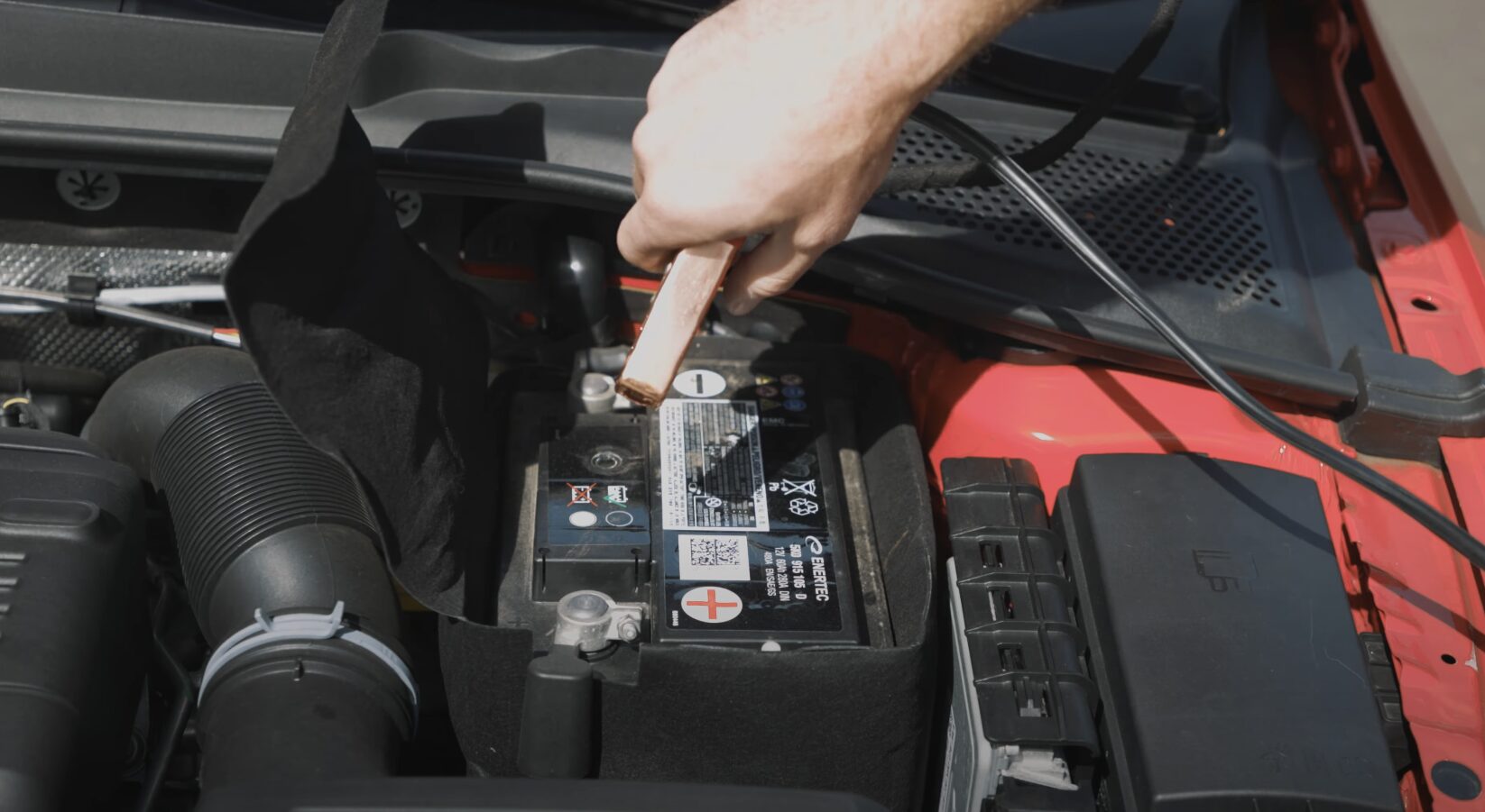 Roadside Assistance Service - Syracuse Towing Service Roadside assistance technician providing battery jump start service in Syracuse UT